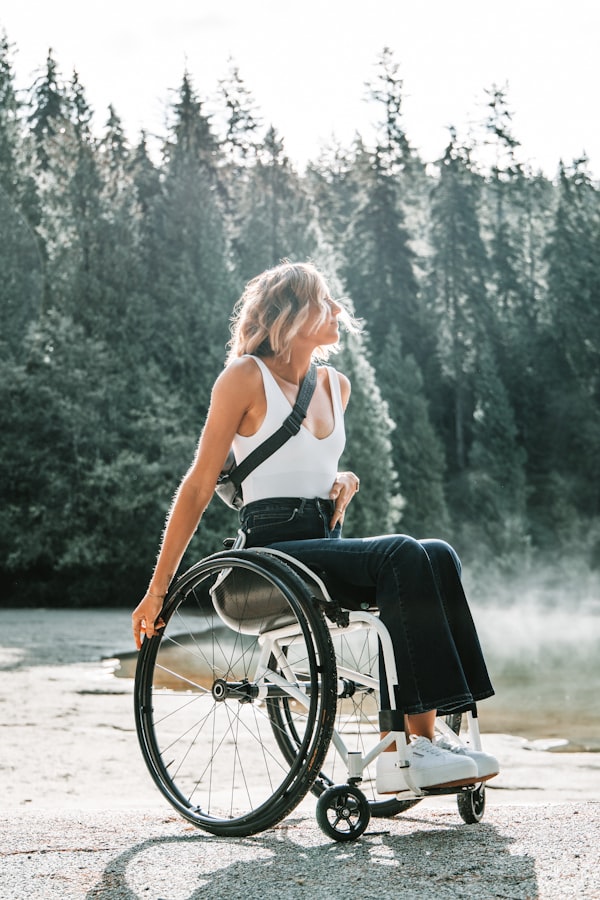 Woman in a wheelchair outdoors among trees